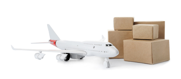 Photo of Toy plane with boxes isolated on white. Logistics and wholesale concept