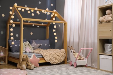 Photo of Stylish child room interior with comfortable bed