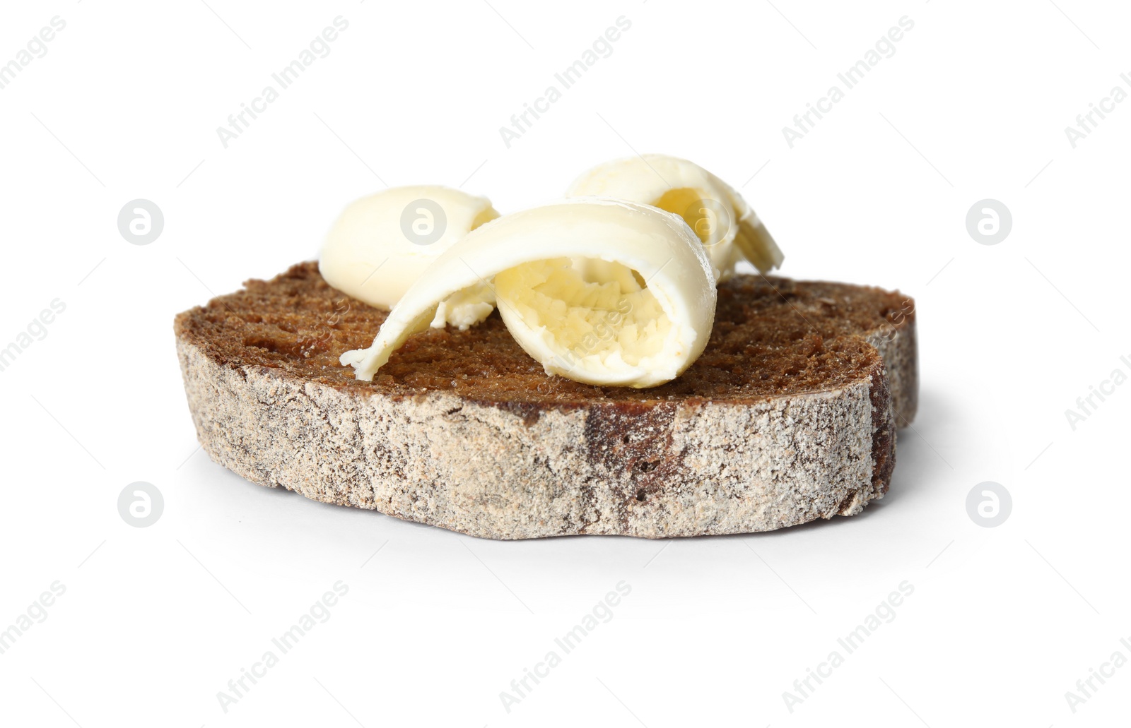 Photo of Slice of bread with butter curls isolated on white