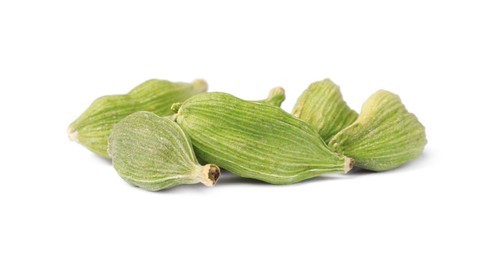 Pile of dry green cardamom on white background
