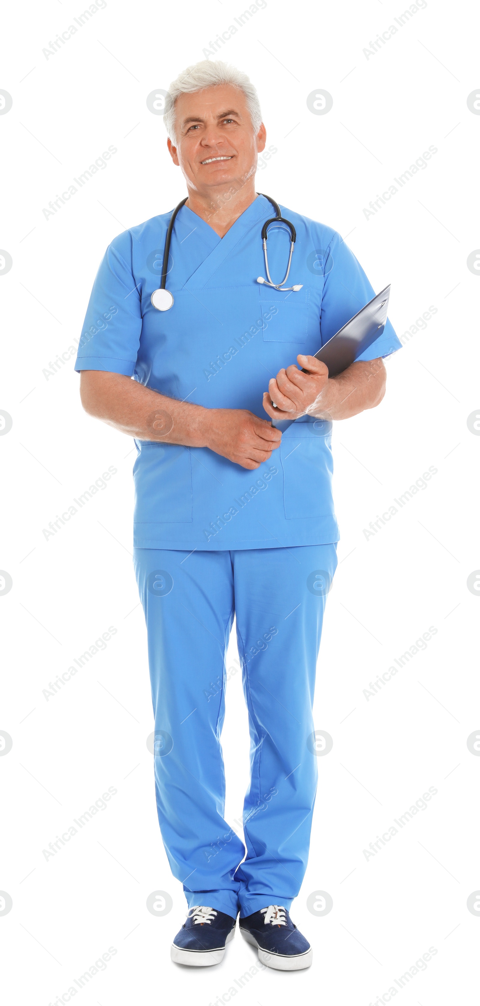 Photo of Full length portrait of male doctor in scrubs with clipboard isolated on white. Medical staff