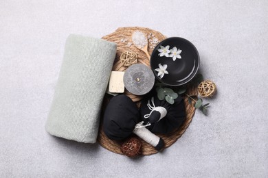Photo of Flat lay composition with herbal massage bags, spa products and flowers on light grey table