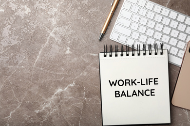 Image of Work-life balance concept. Notebook and keyboard on grey marble table, flat lay