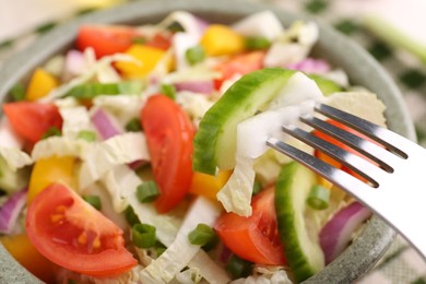 Photo of Eating delicious salad with Chinese cabbage at table, closeup