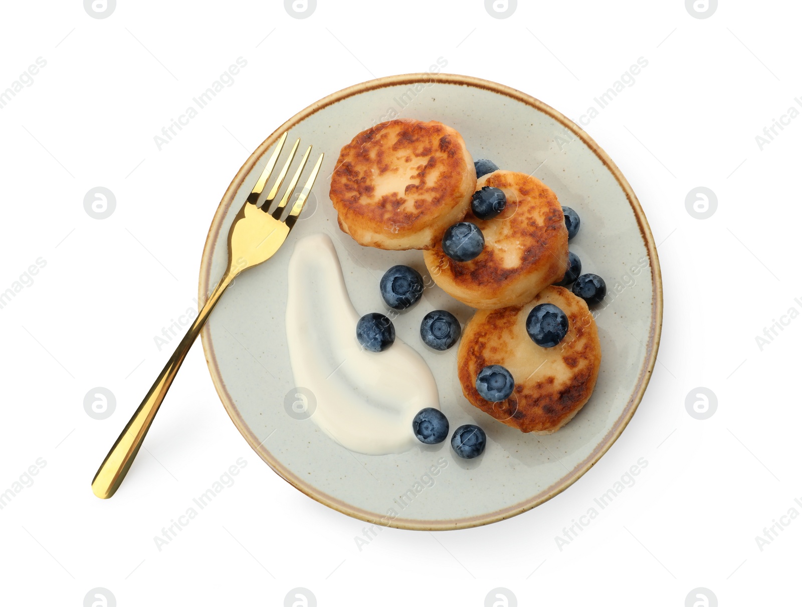 Photo of Delicious cottage cheese pancakes served with fresh blueberries and sour cream on white background, top view