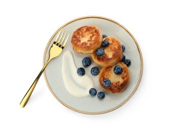 Delicious cottage cheese pancakes served with fresh blueberries and sour cream on white background, top view