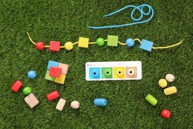 Educational toy for motor skills development on artificial grass, flat lay