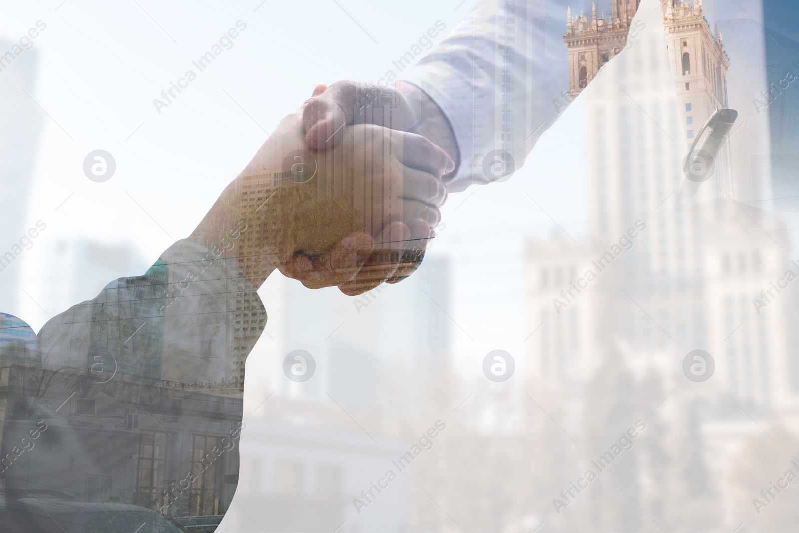 Image of Double exposure of partners shaking hands and cityscape