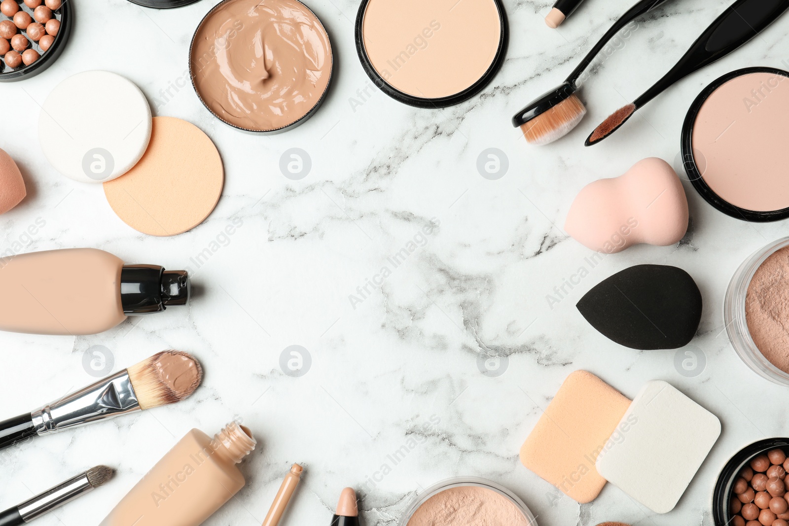 Photo of Flat lay composition with skin foundation, powder and beauty accessories on marble background. Space for text