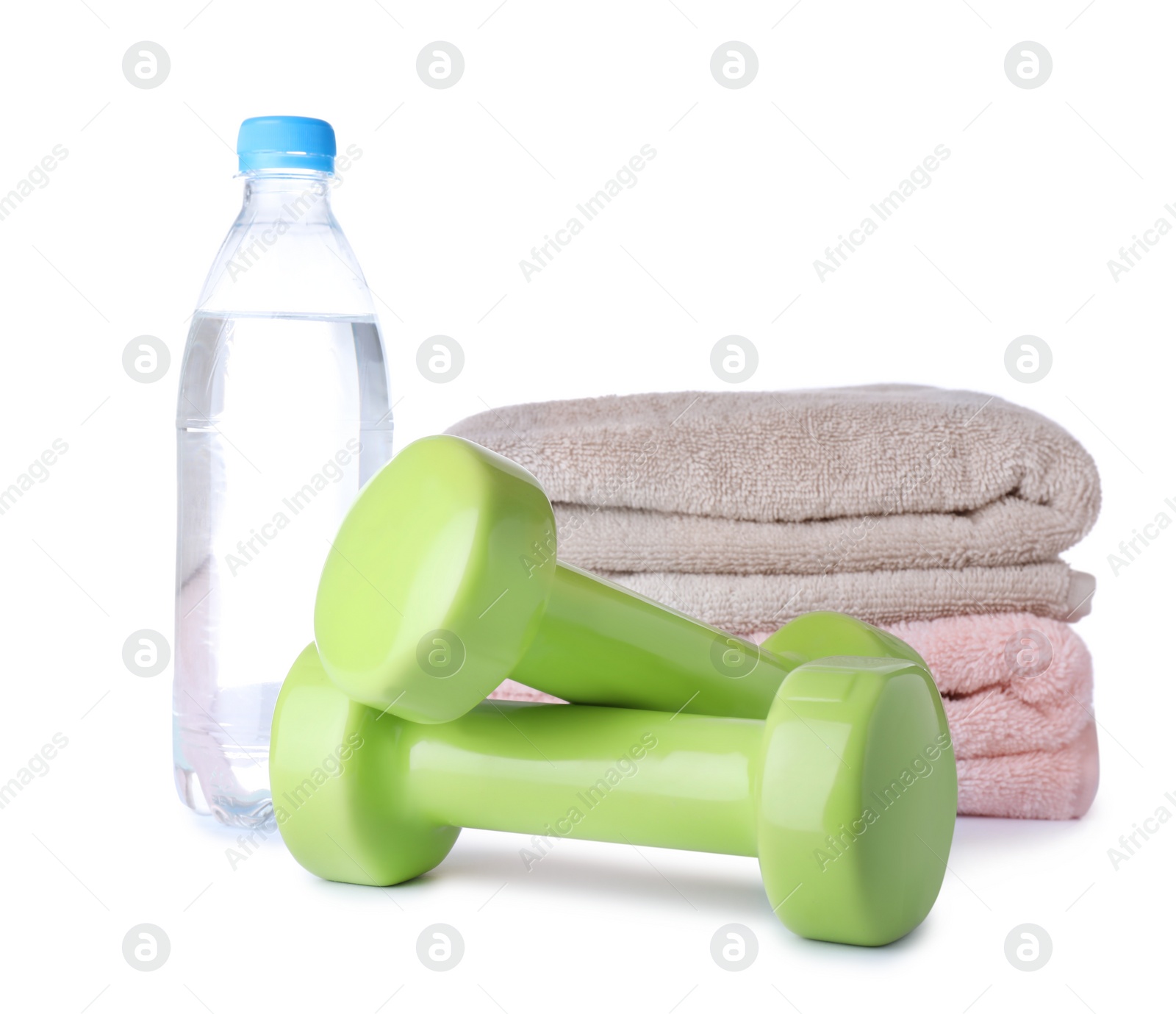 Photo of Stylish dumbbells, bottle of water and towels on white background. Home fitness