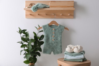 Photo of Cute children's clothes and shoes in room