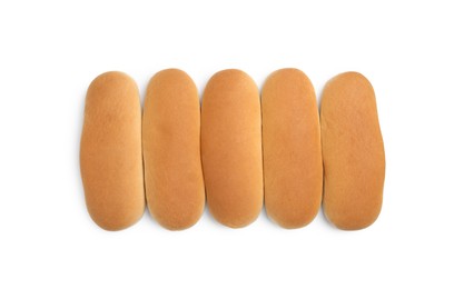 Photo of Tasty fresh buns for hot dogs on white background, top view