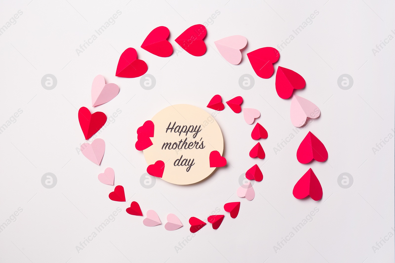 Photo of Greeting card with phrase "HAPPY MOTHER'S DAY" and paper hearts on white background