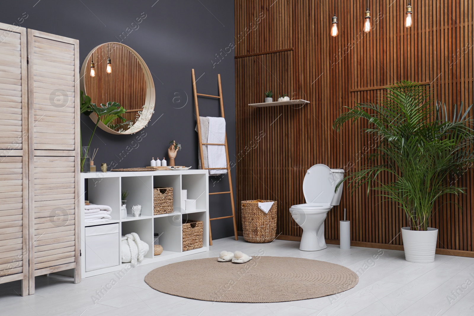 Photo of Interior of modern bathroom with round mirror