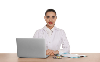 Professional pharmacist with laptop at table against white background