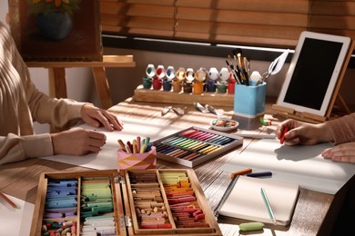 Artists drawing with soft pastels at table, closeup