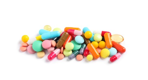 Photo of Heap of different colorful pills isolated on white