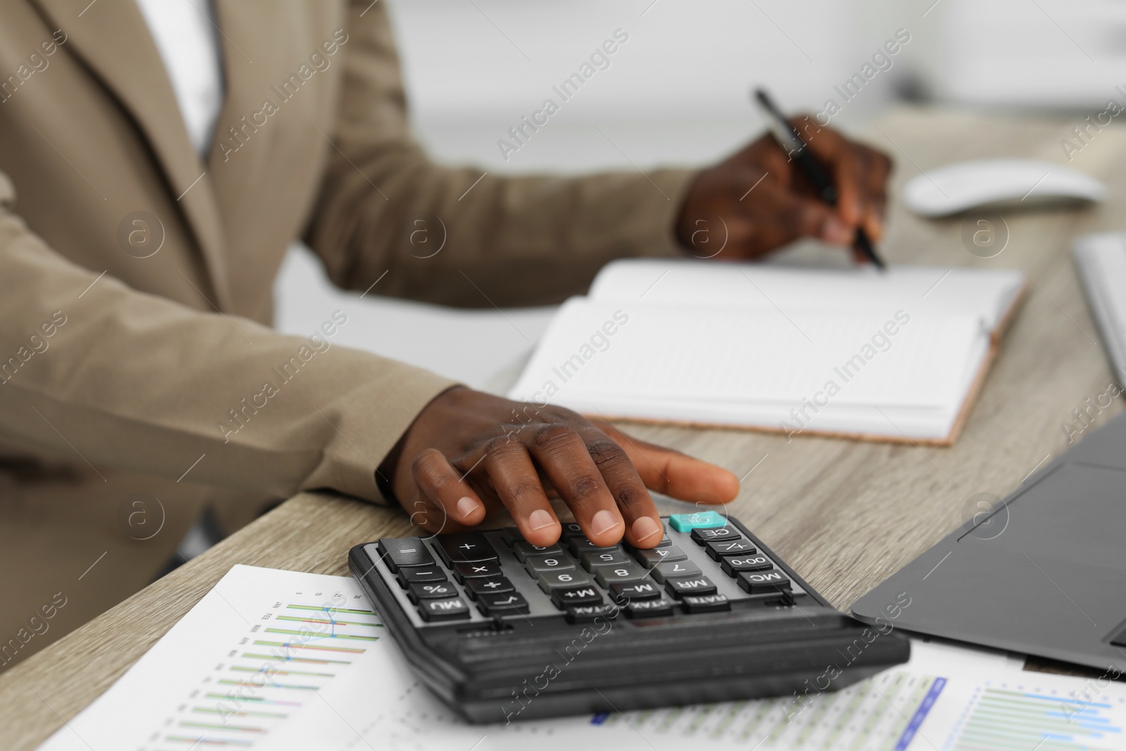 Photo of Professional accountant working at wooden desk in office, closeup