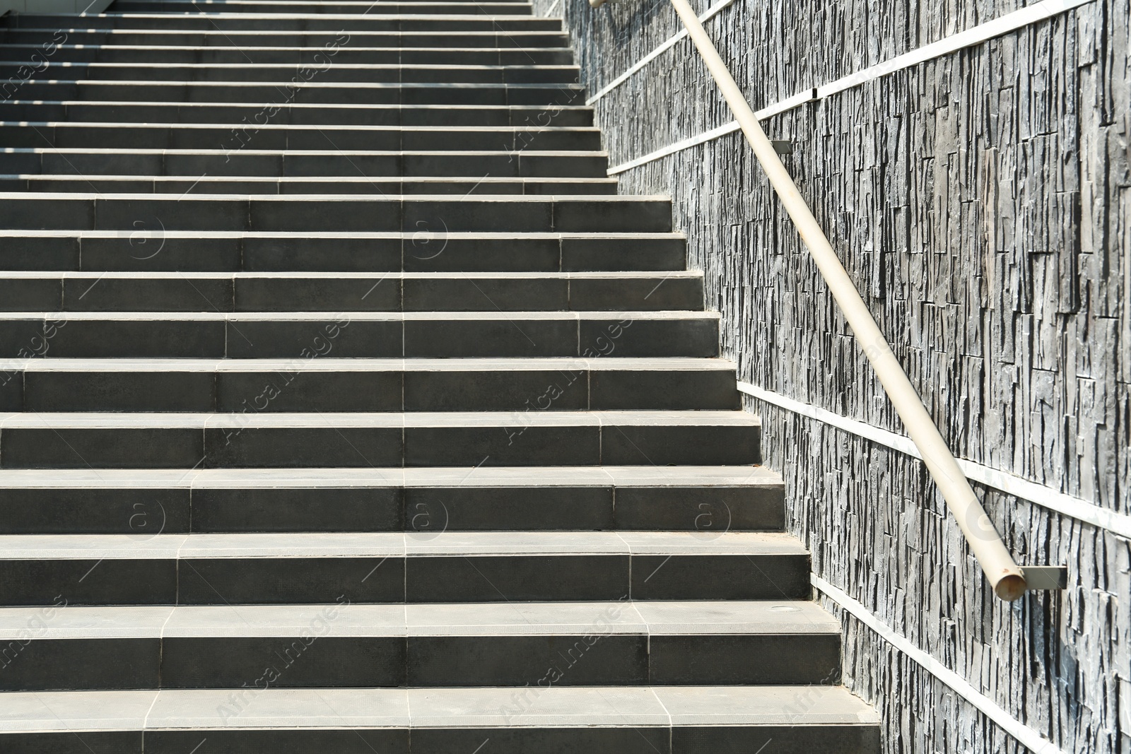 Photo of Stairs with metal handrailing outdoors on sunny day