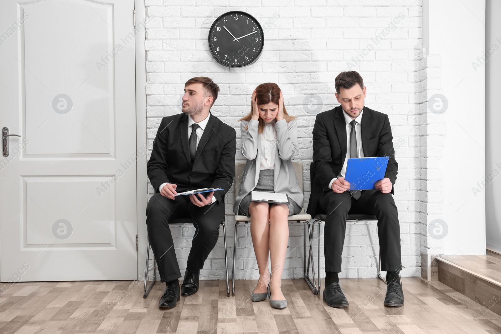 Photo of Group of people waiting for job interview, indoors