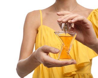 Young woman with perfume bottle on white background, closeup