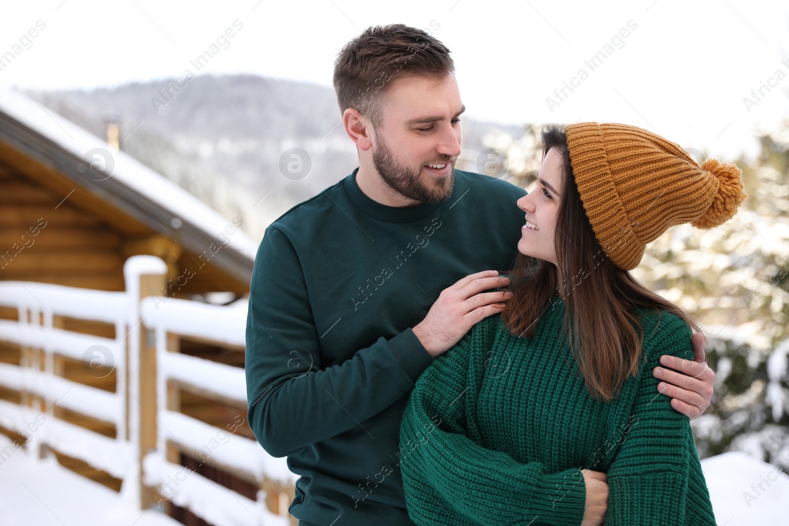 Photo of Lovely couple spending time together on snowy day. Winter vacation