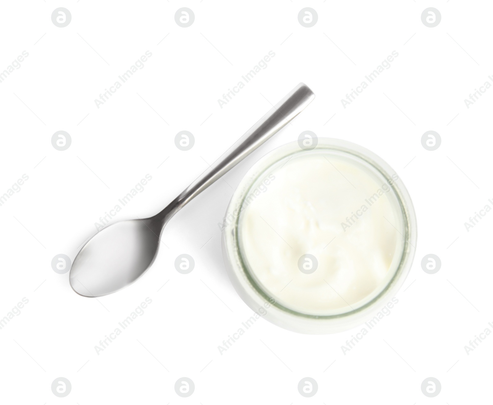 Photo of Tasty organic yogurt in glass jar and spoon isolated on white, top view