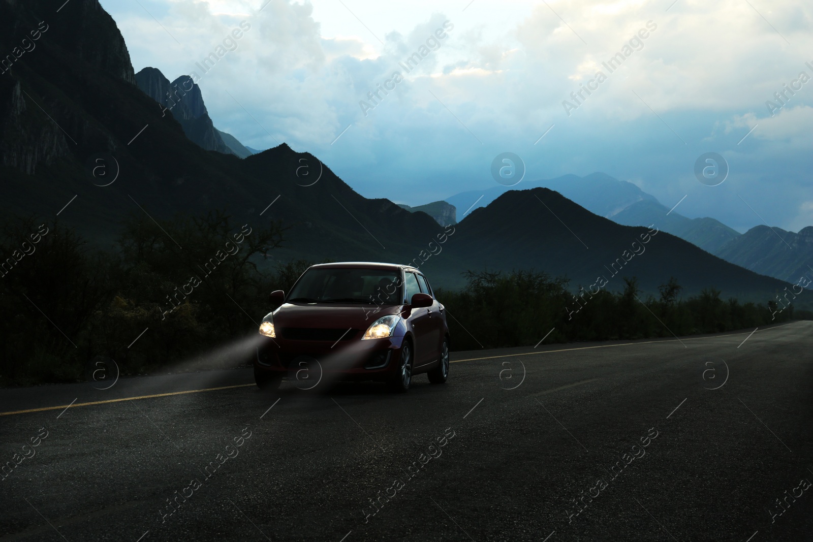 Photo of Beautiful view of car on asphalt highway in mountains. Road trip