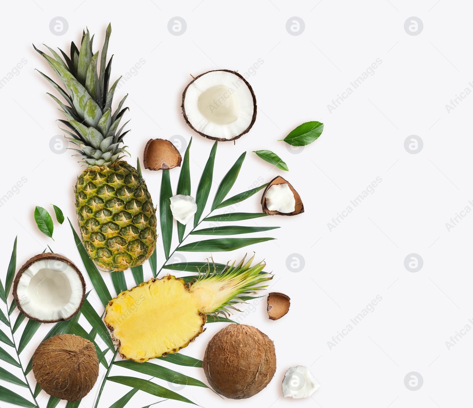 Image of Tropical layout with fresh exotic fruits and green leaves on white background, top view