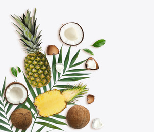 Image of Tropical layout with fresh exotic fruits and green leaves on white background, top view