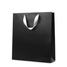 Photo of Paper shopping bag with ribbon handles on white background. Mockup for design