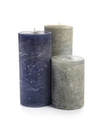 Photo of Different decorative wax candles on white background