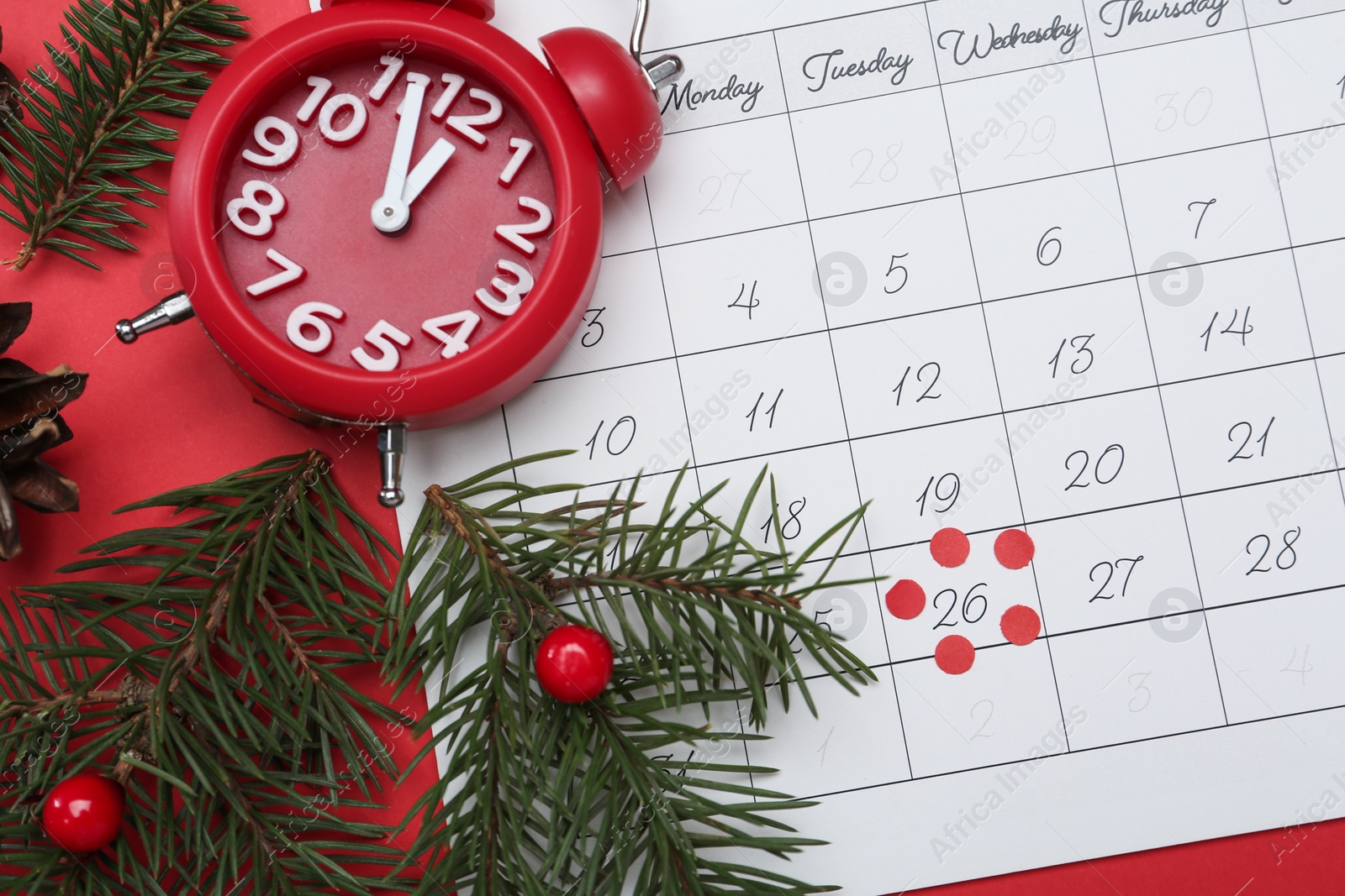 Photo of Flat lay composition with calendar and alarm clock on red background. Boxing Day