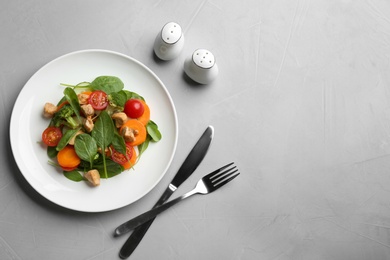 Photo of Delicious fresh chicken salad served on grey table, flat lay. Space for text