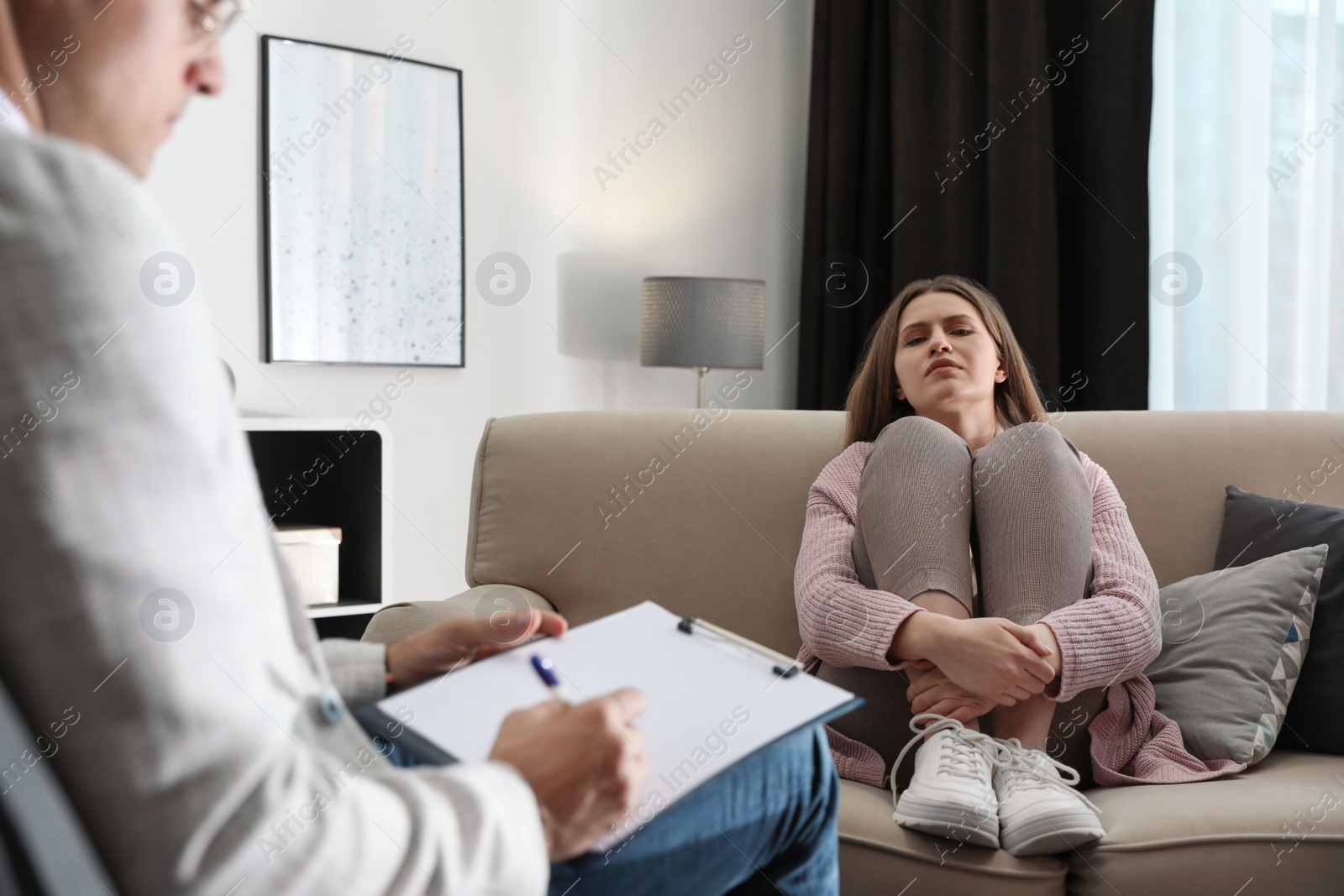 Photo of Professional psychotherapist working with patient in office