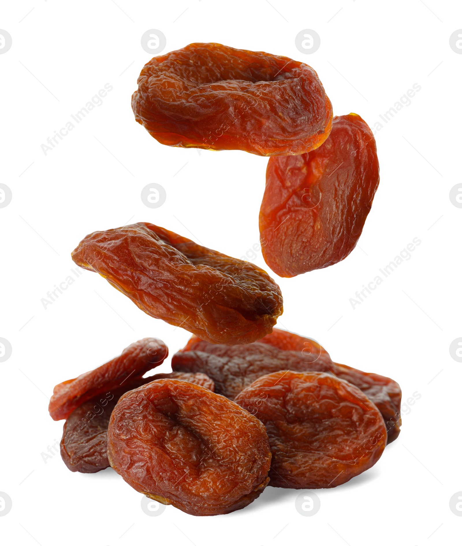 Image of Tasty dried apricots falling on white background