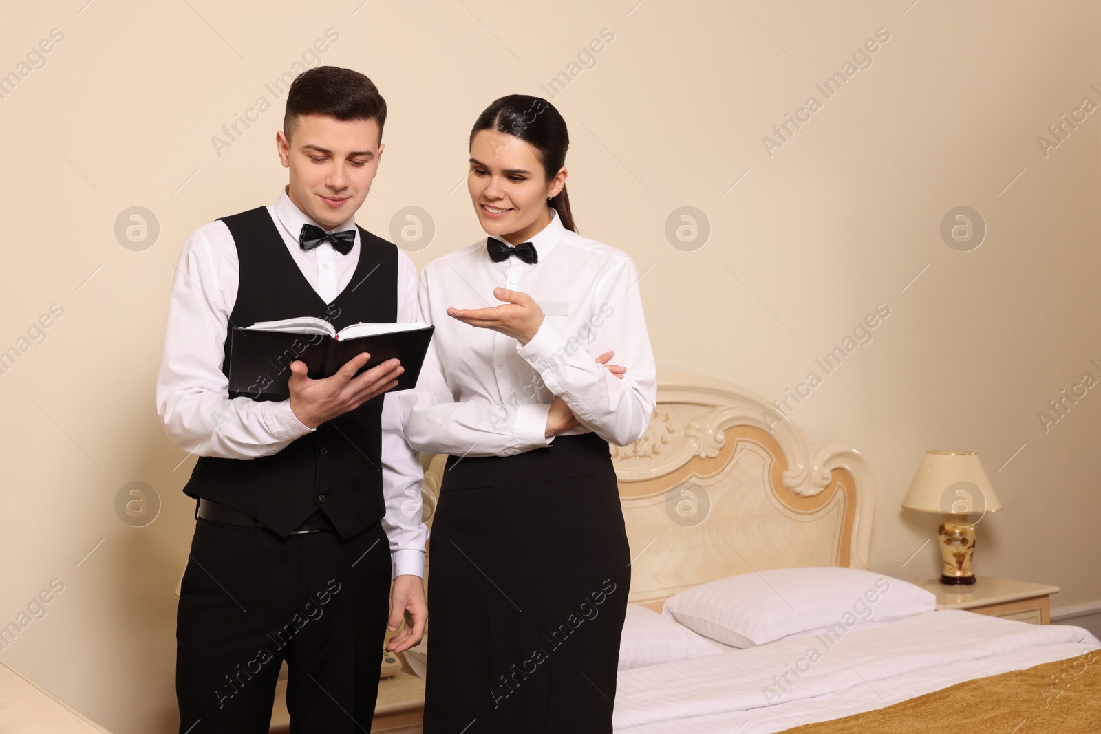 Photo of Young people attending professional butler courses in hotel. Space for text