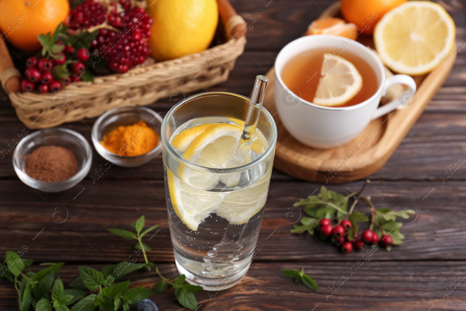 Photo of Delicious immunity boosting drink and ingredients on wooden table