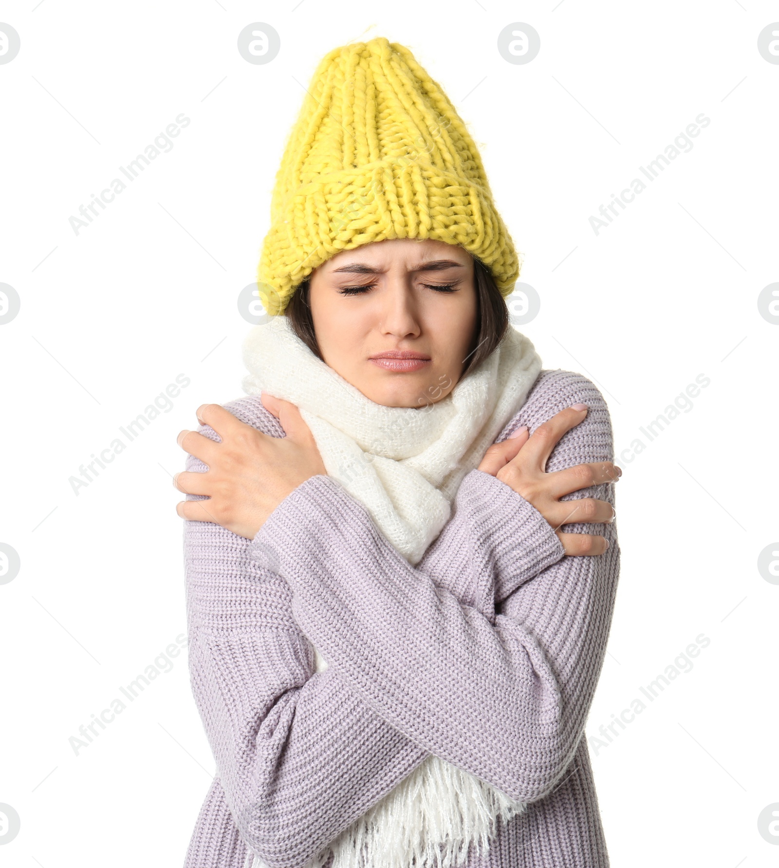 Photo of Young woman in warm clothes suffering from cold on white background