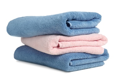 Photo of Folded soft terry towels on white background