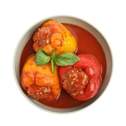 Delicious stuffed peppers with basil in bowl isolated on white, top view