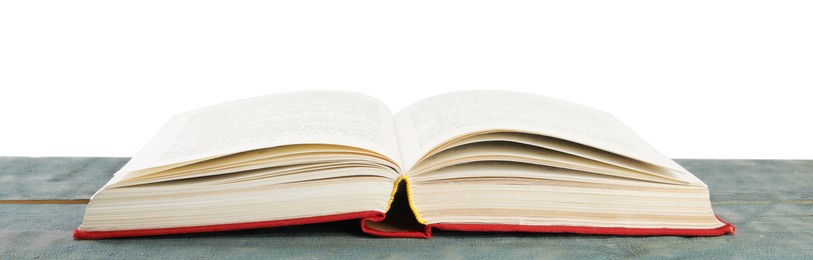 Photo of Open old hardcover book on wooden table