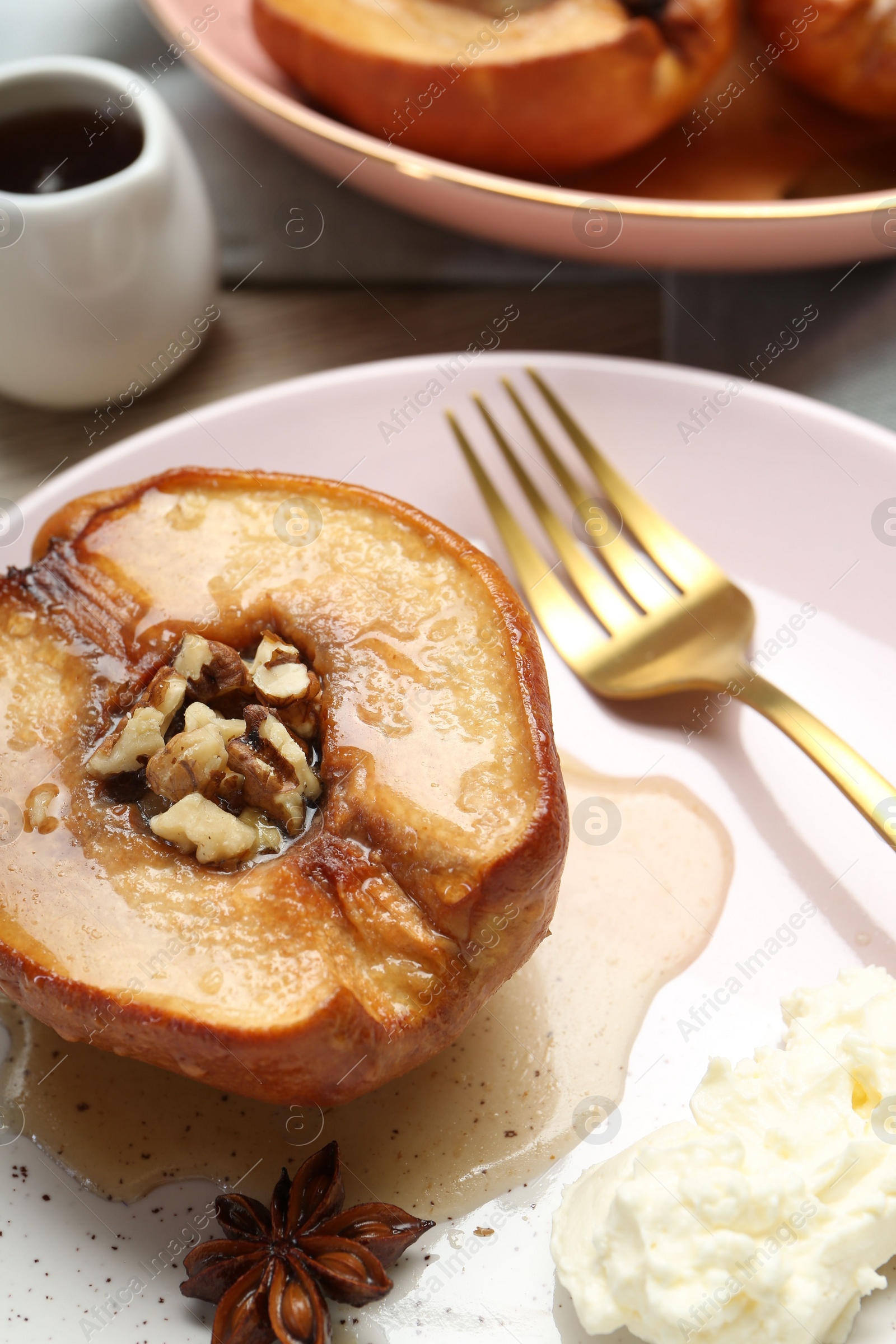 Photo of Delicious quince baked with honey and walnuts on table, closeup