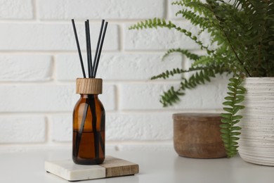 Photo of Air reed freshener on table against white wall