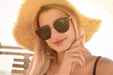 Beautiful woman wearing sunglasses outdoors on sunny day, closeup