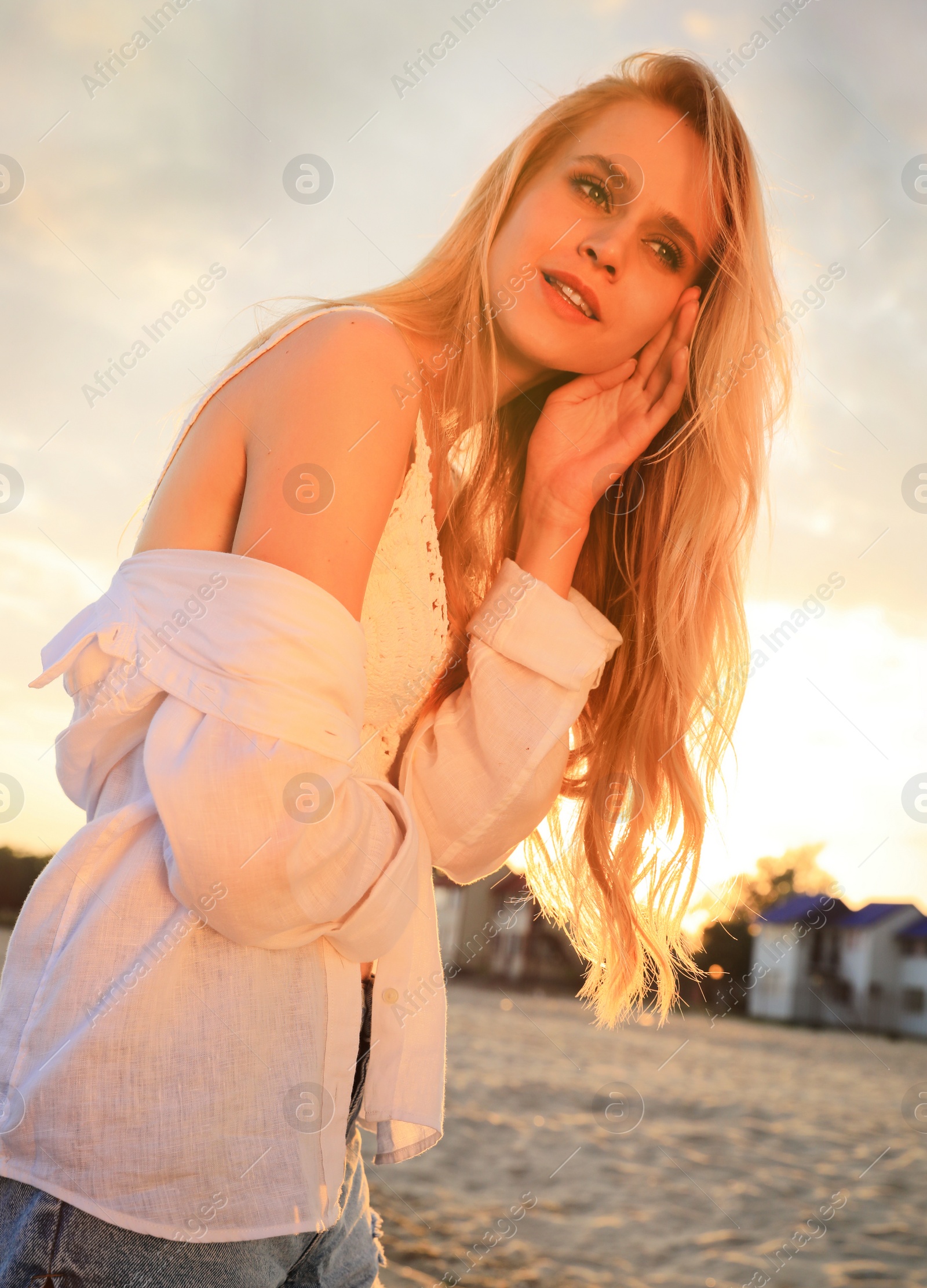 Photo of Beautiful young woman on beach at sunset