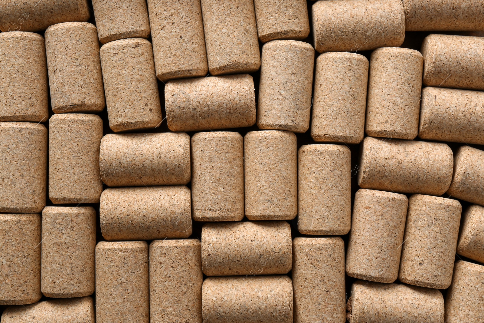 Photo of Many corks of wine bottles as background, top view