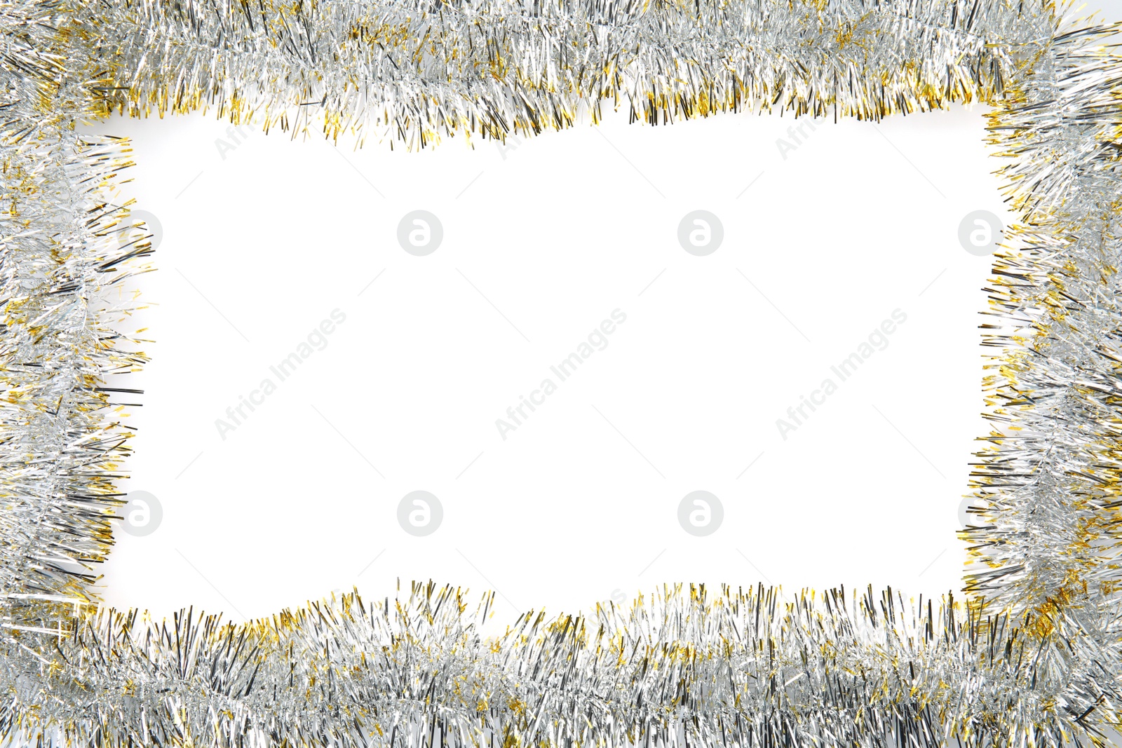 Photo of Frame of shiny tinsel on white background, top view. Space for text