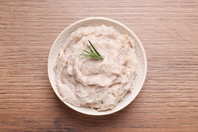 Delicious lard spread in bowl on wooden table, top view