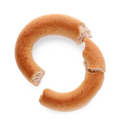 Photo of Crushed tasty dry bagel (sushki) on white background, top view